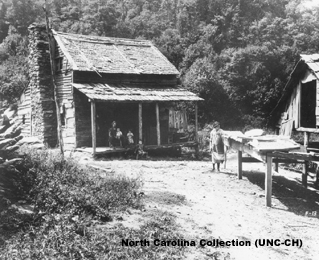 Black and white photograph of a small farm house